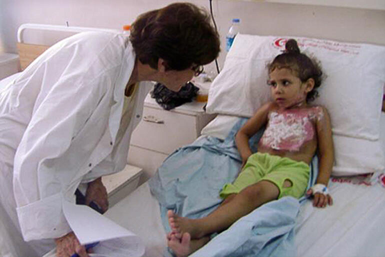 A child with blast wounds is treated at Al Ahli Hospital during 2014 bombing. Right now, the hospital sees up to 40 more injured people daily.