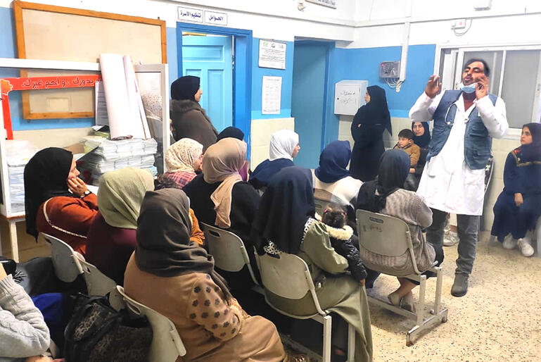 A doctor at the Middle East Council of Churches' DSPR Rafah clinic offers health awareness training to women taking refuge from bombing in Gaza.