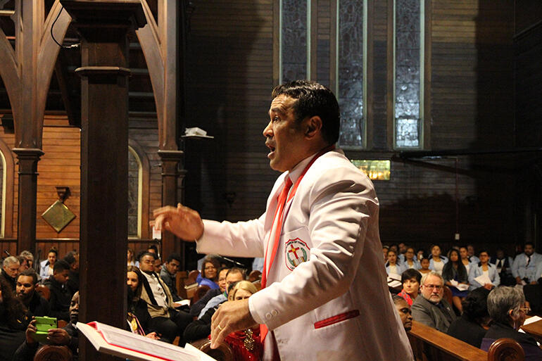The conductor of the United Church of Tonga at work.