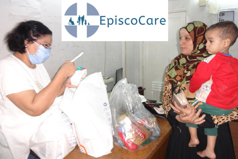 A Diocese of Egypt Episcocare health worker talks a mother through her child's prescription.